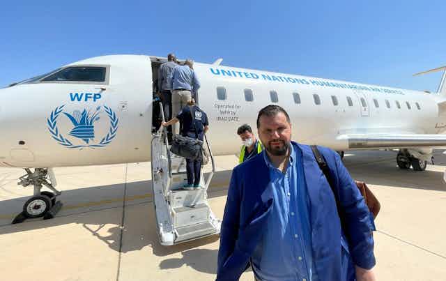 Dan Stoenescu in front of a World Food Programme plane