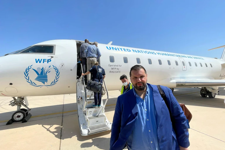Dan Stoenescu in front of a World Food Programme plane