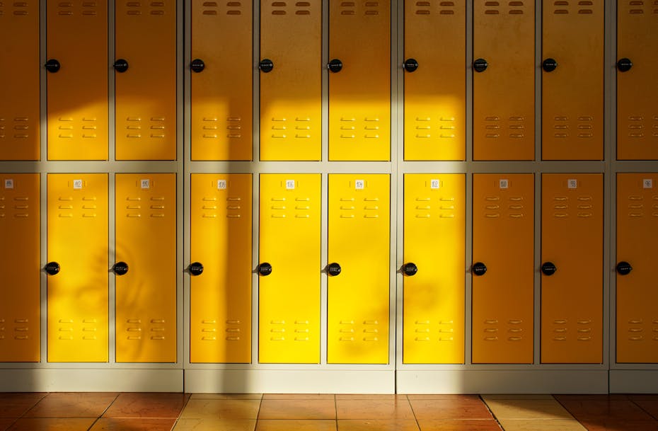 A row of lockers seen, some that are sunlit.