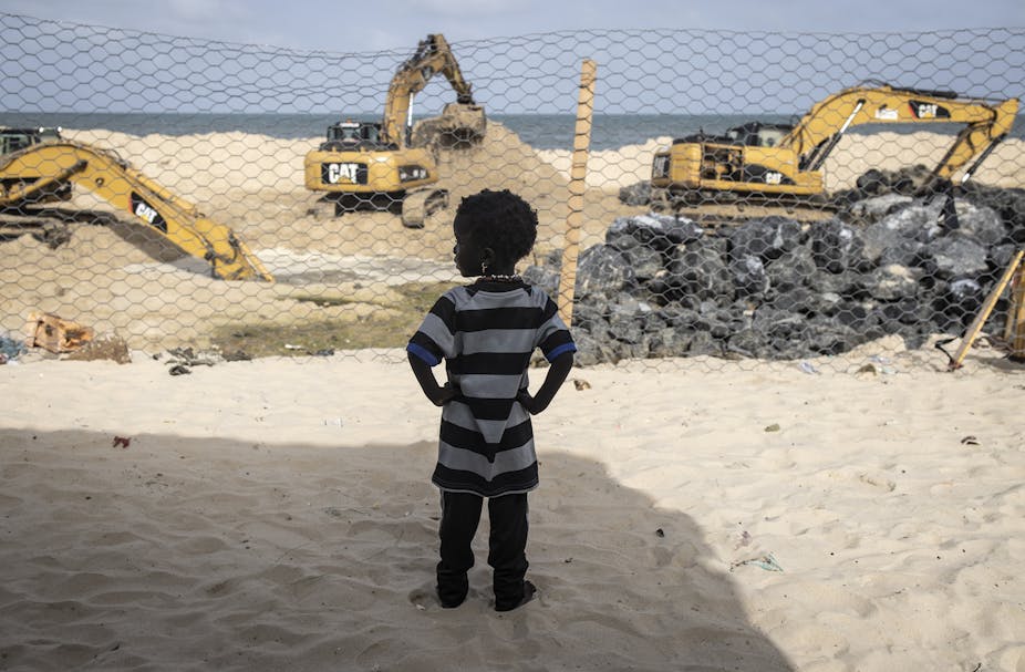 A Senegalese girl watching the construction of a dam