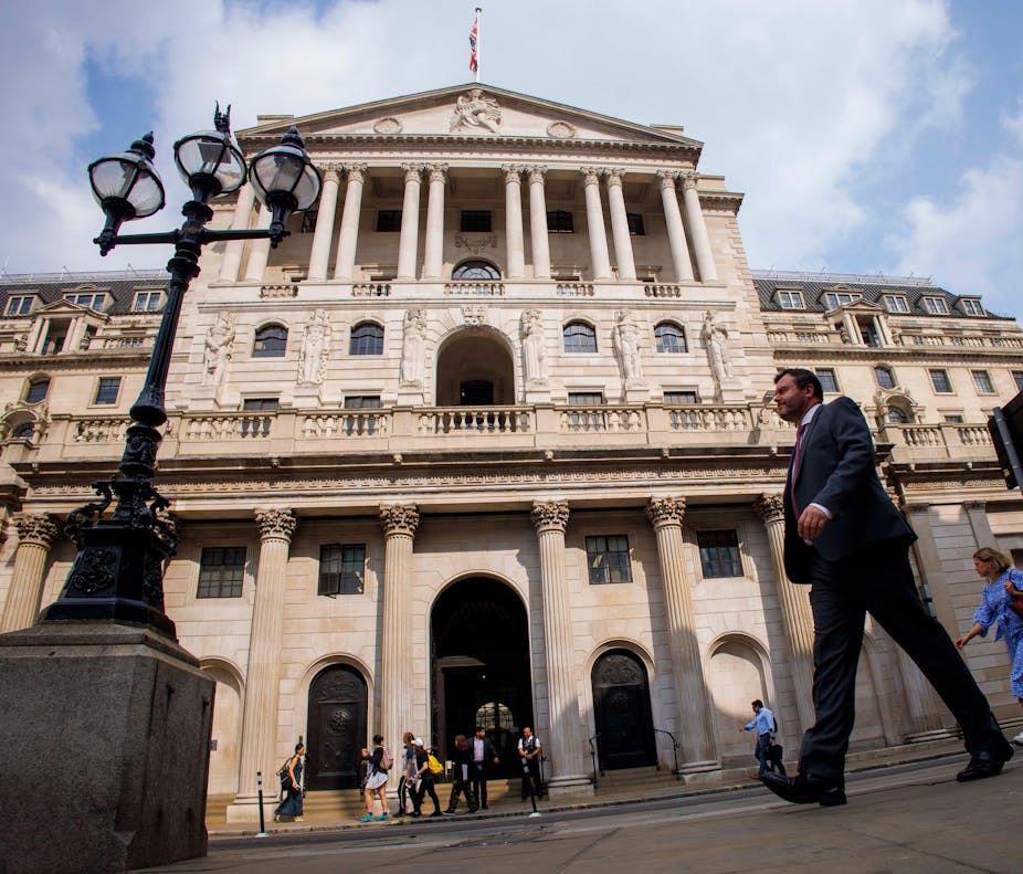 People walking past the Bank of England in the City of London.