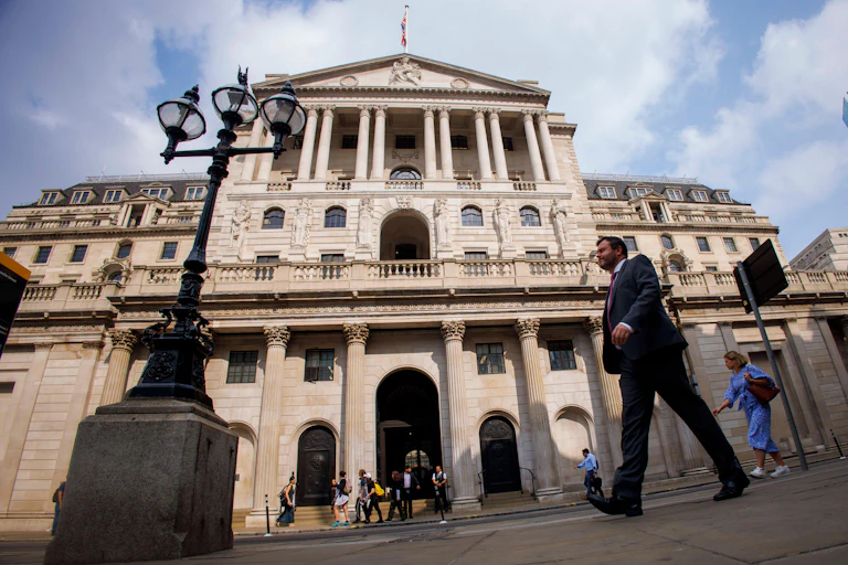 People walking past the Bank of England in the City of London.