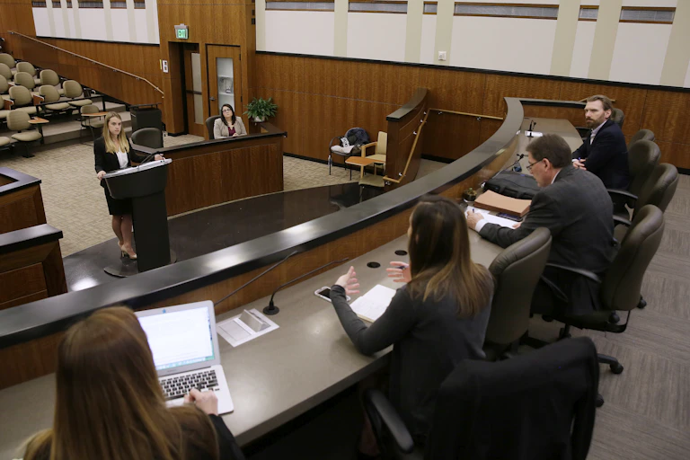Young people in business attire in a classroom