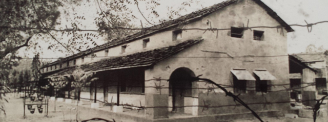 A sepia photograph of a large white building where Chinese people were held after the Sino-Indian conflict.