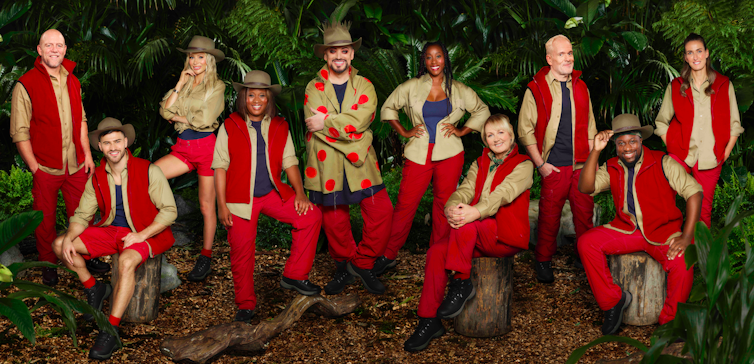The ten contestants pose together in the jungle