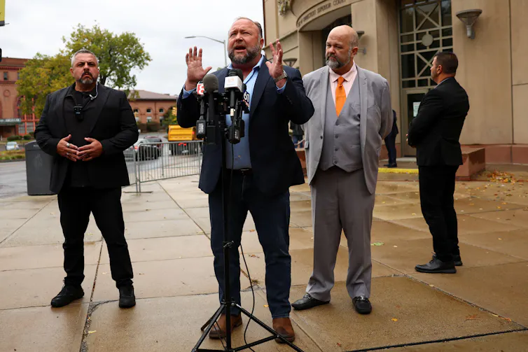 Alex Jones speaks to the press during his Sandy Hook lawsuit