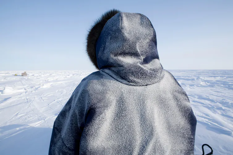 Inuit looks over ice landscape