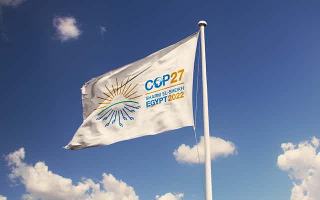 a flag flying with the text COP27 SHARM EL-SHEIKH EGYPT 2022