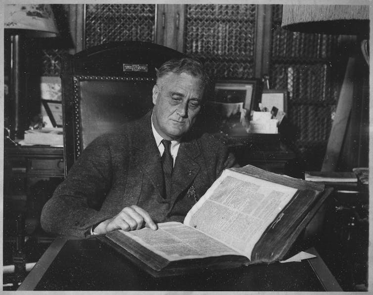 Man reading large book