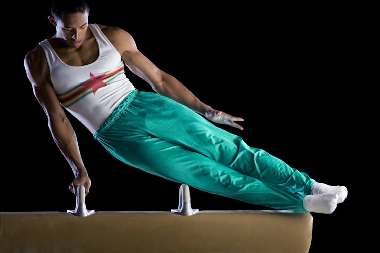 Male gymnast on pommel horse