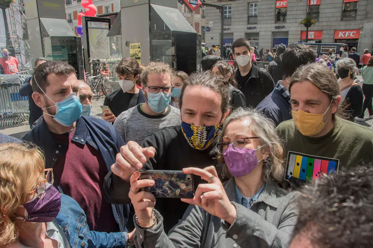 People taking selfie among a crowded street