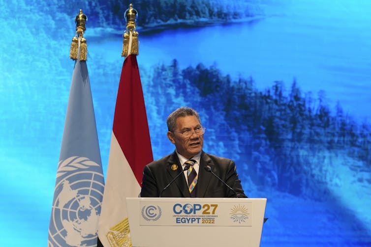 Tuvalu Prime Minister behind a podium at COP27
