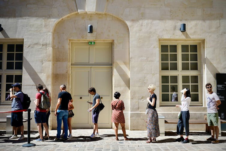 People wait in a queue