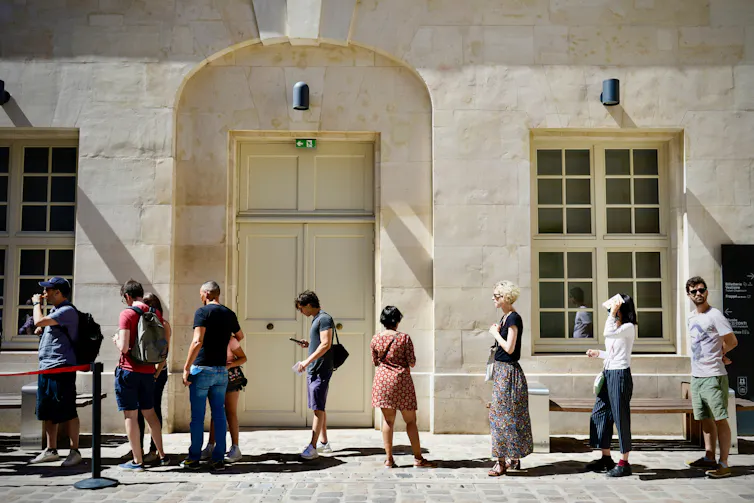 People wait in a queue