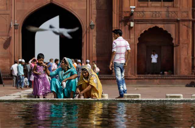 Indian Muslim women near a fountain in New Delhi, India