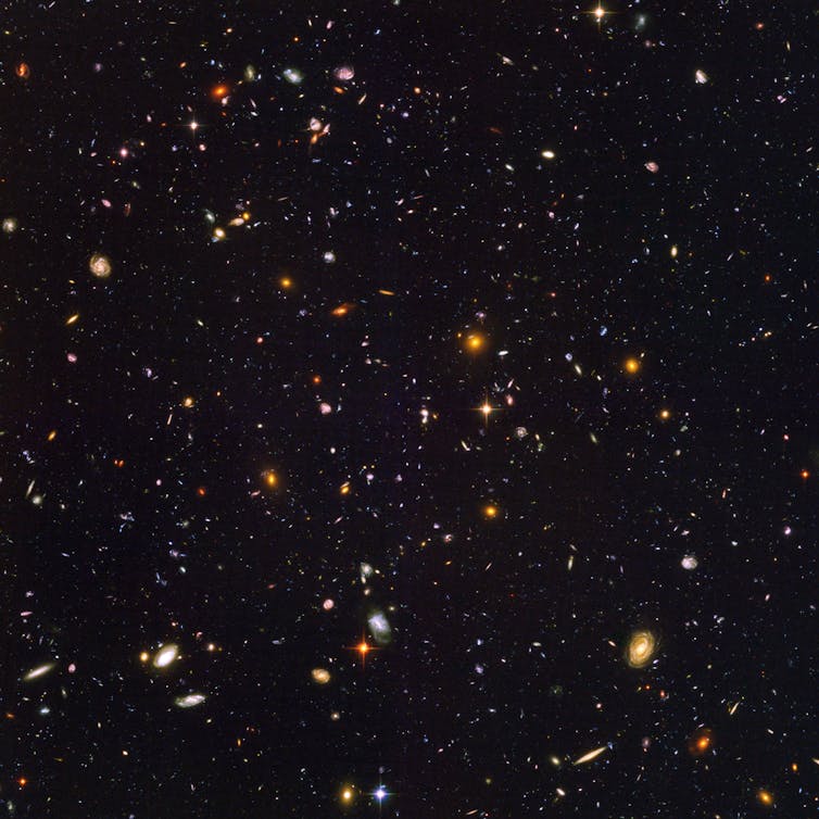 An image of the night sky, containing almost 10,000 galaxies. The galaxies are a variety of shapes and colours