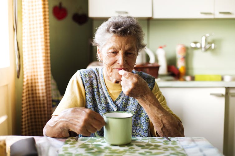 A senior woman taking a tablet.