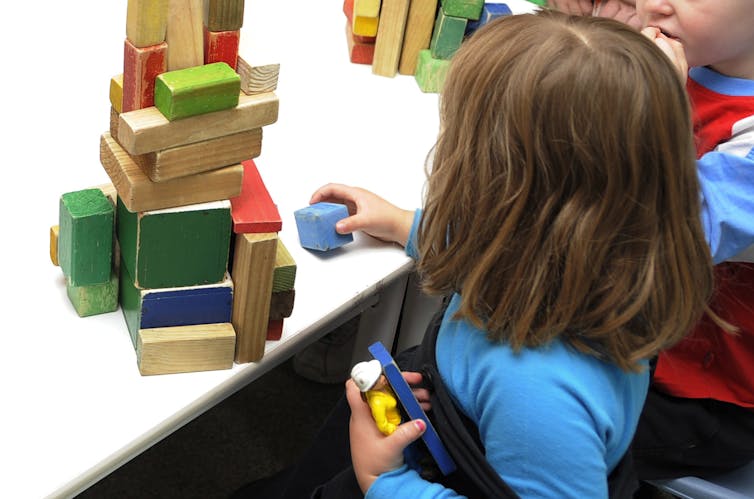 A child playing with wooden blocks.