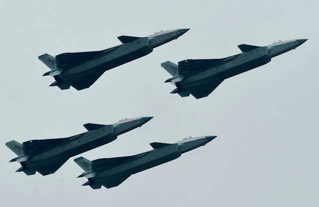 Four Chinese fighter jets flying in formation
