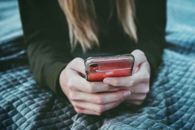 A woman texting on her iphone