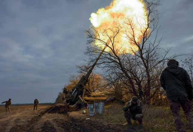 Ukrainian personnel fire a canon in the Kherson area.