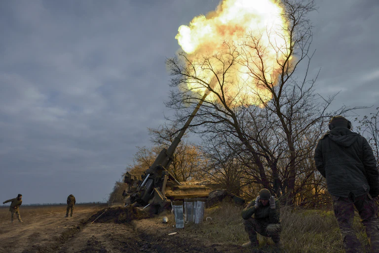Ukrainian personnel fire a canon in the Kherson area.