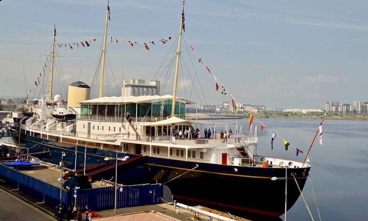 The Royal Yacht Britannia berthed at a port.