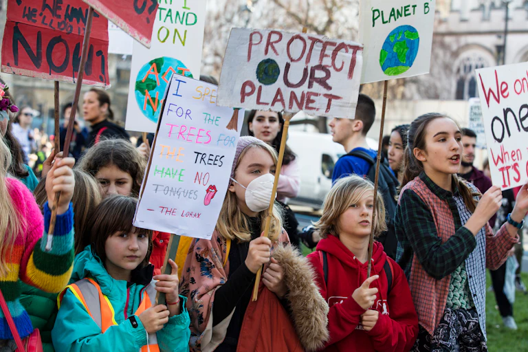 Young climate protestors carrying placards.