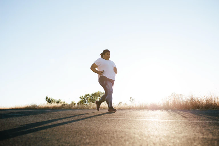 Woman jogging on a country road