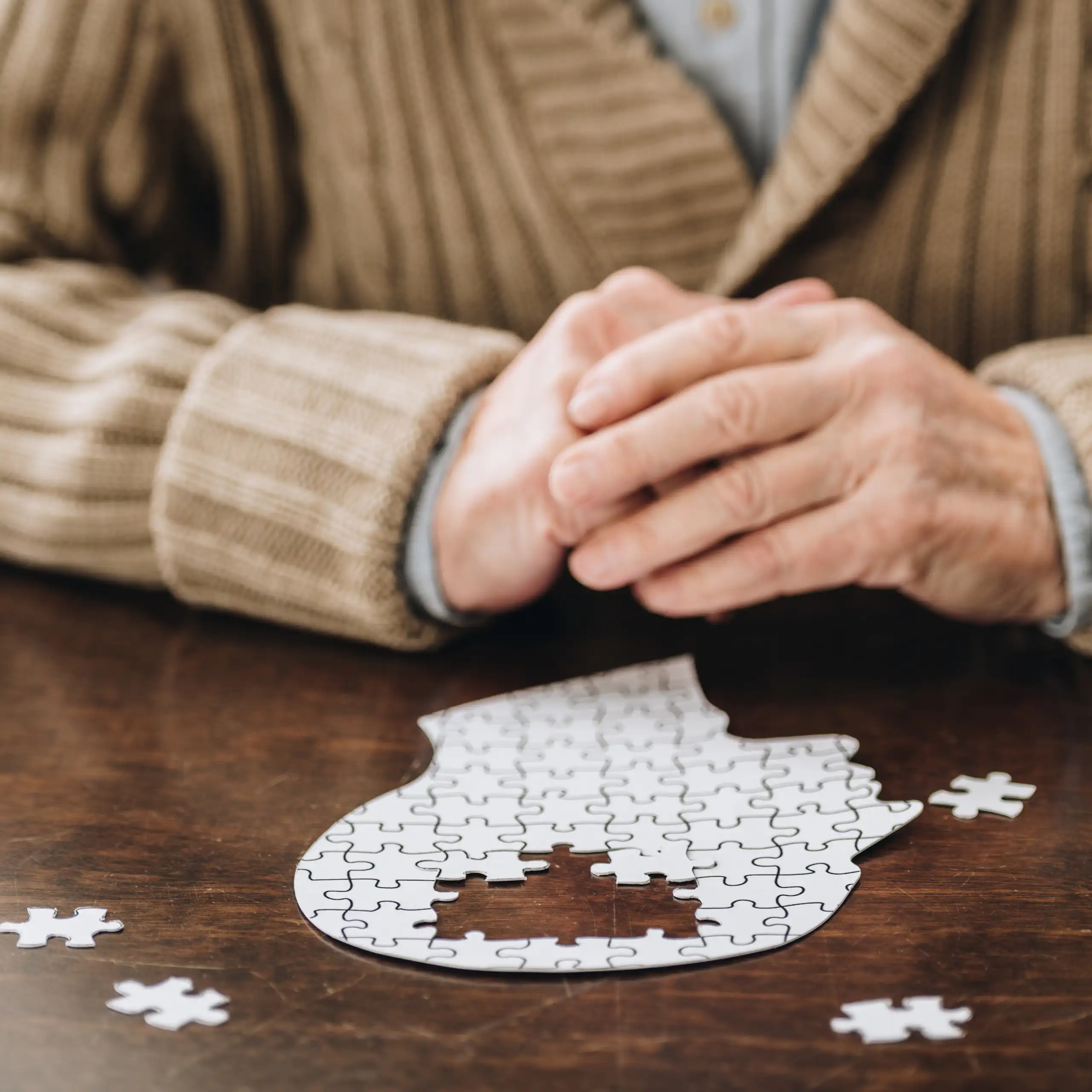 A man playing with a puzzle in the shape of the brain.