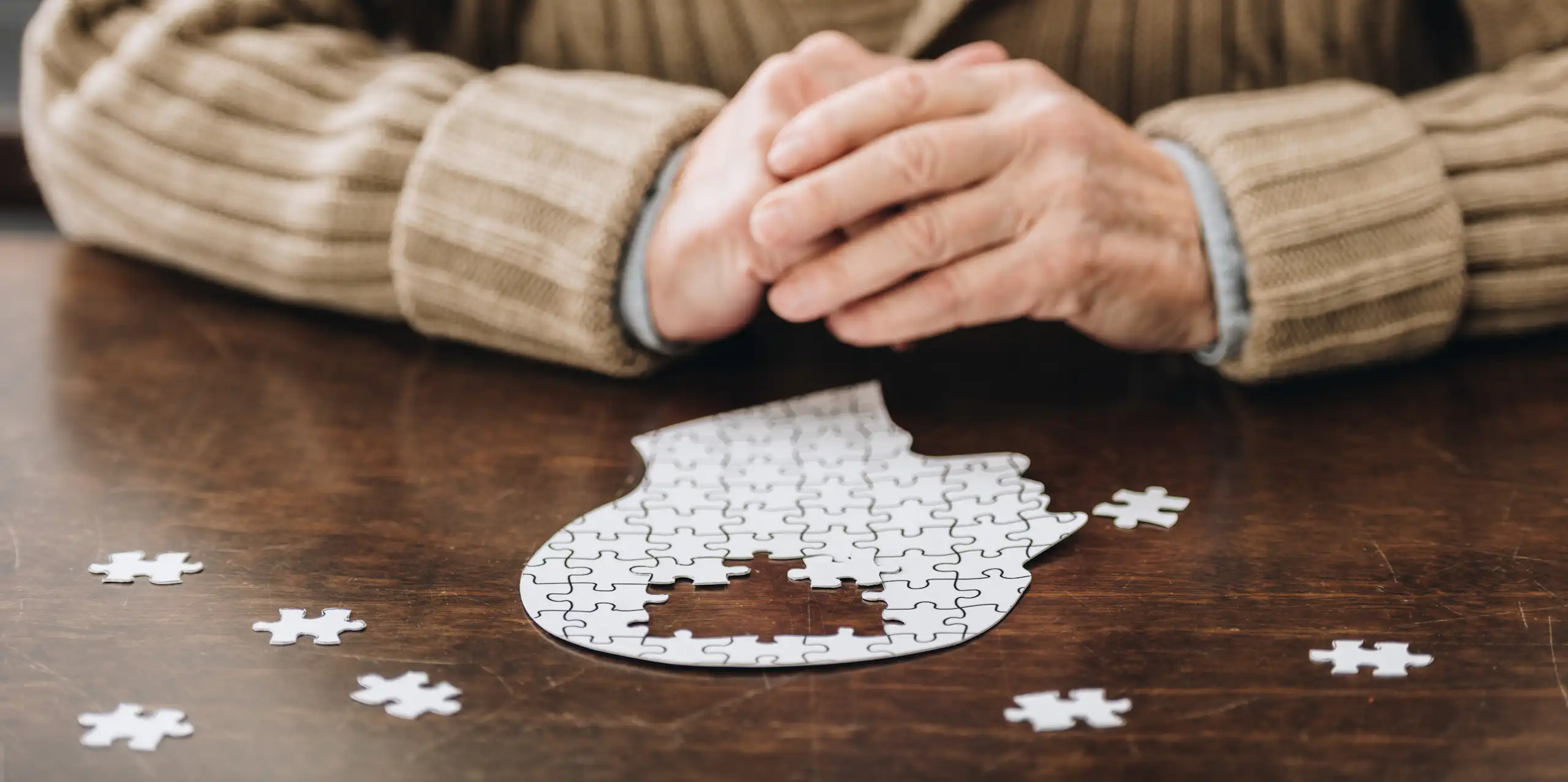 A man playing with a puzzle in the shape of the brain.