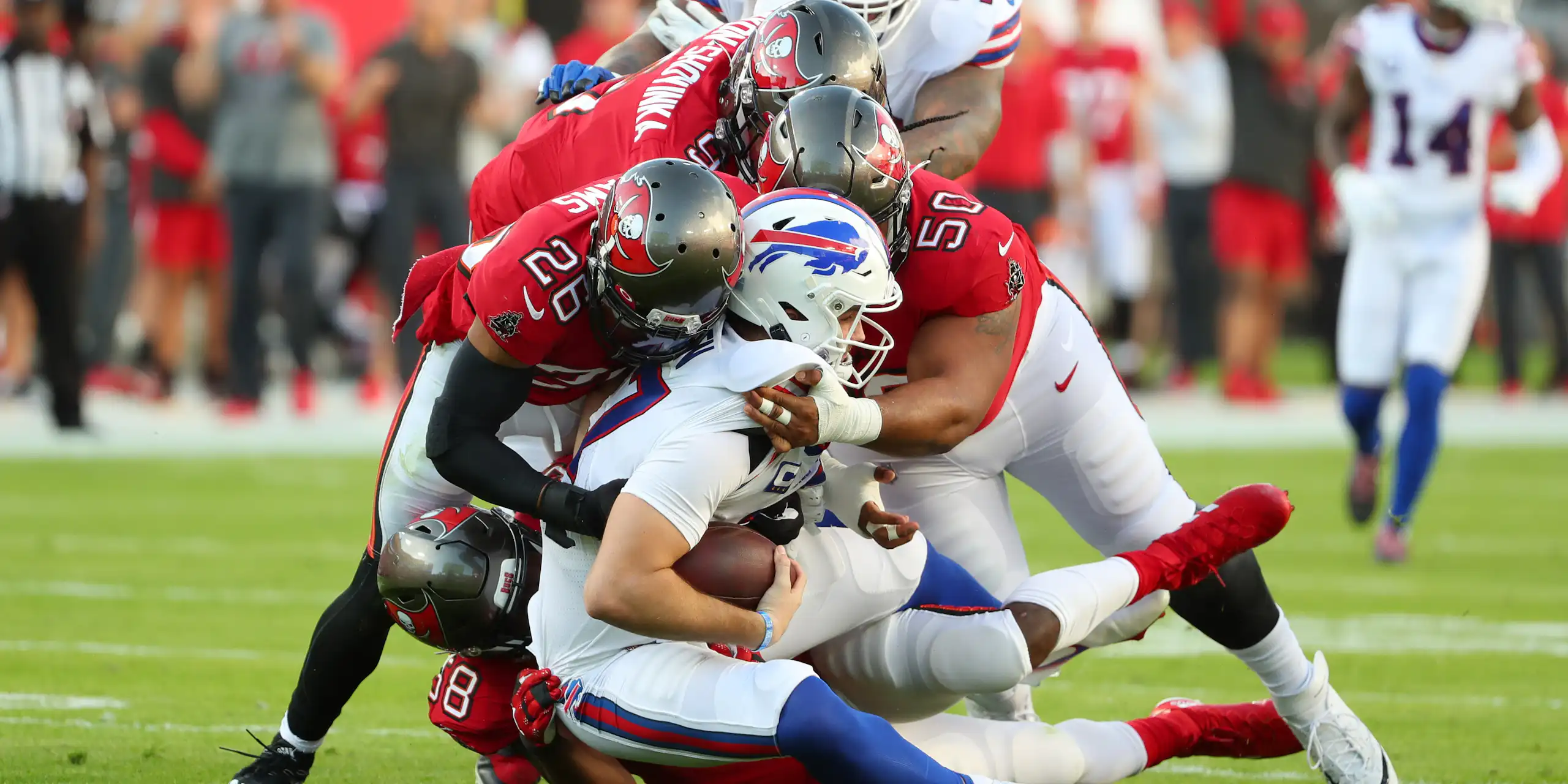 American football players collide on the pitch.