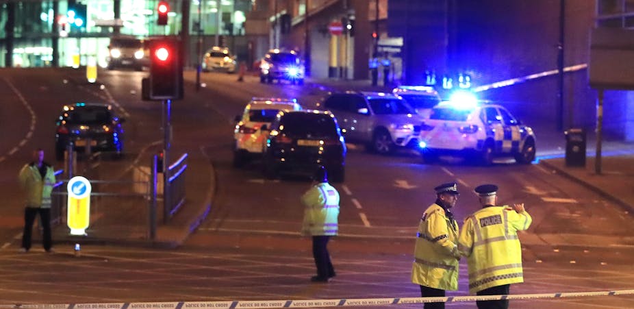 Police officers and emergency services outside the Manchester Arena after an explosion was reported.