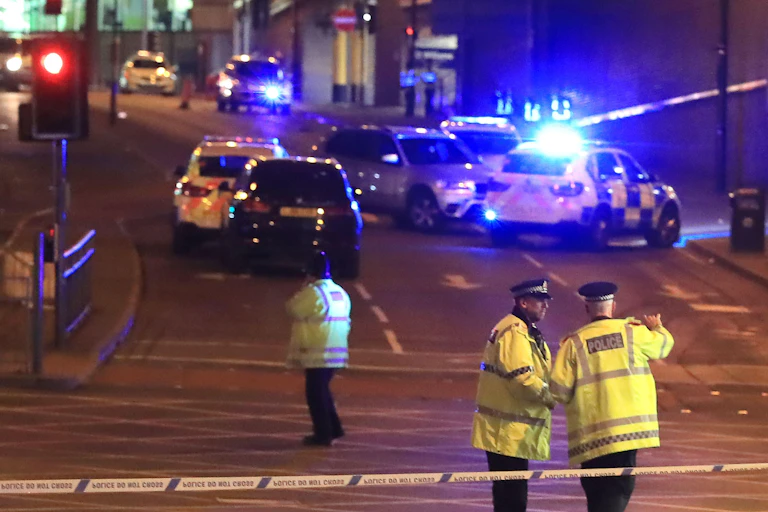 Police officers and emergency services outside the Manchester Arena after an explosion was reported.