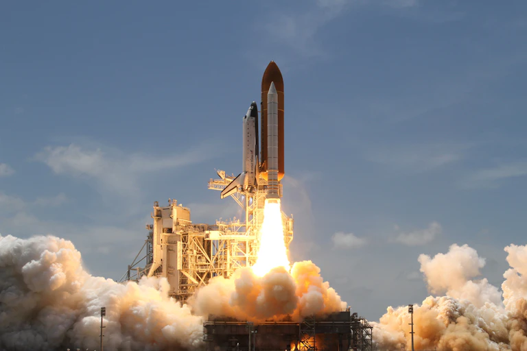 A rocket with a shuttle taking off.