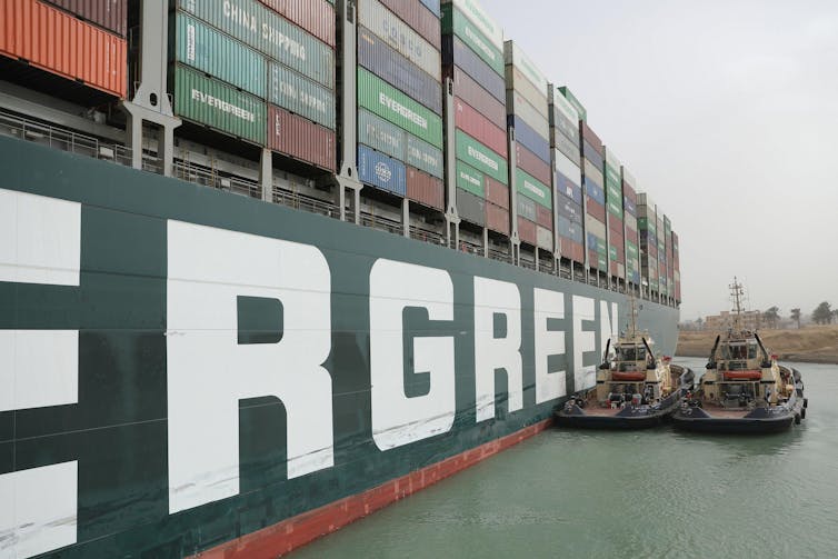 A close-up of a big boat stuck in a canal.