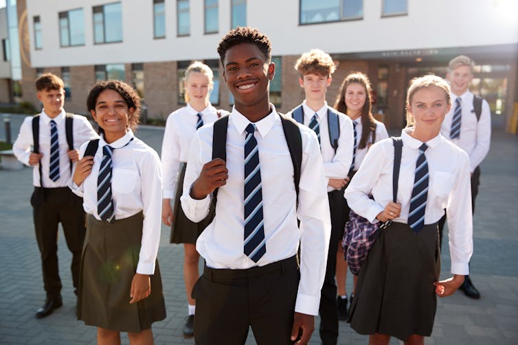 A group of school pupils in uniform outside.