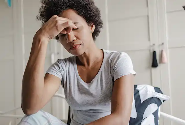 Young African American woman who looks very tired.