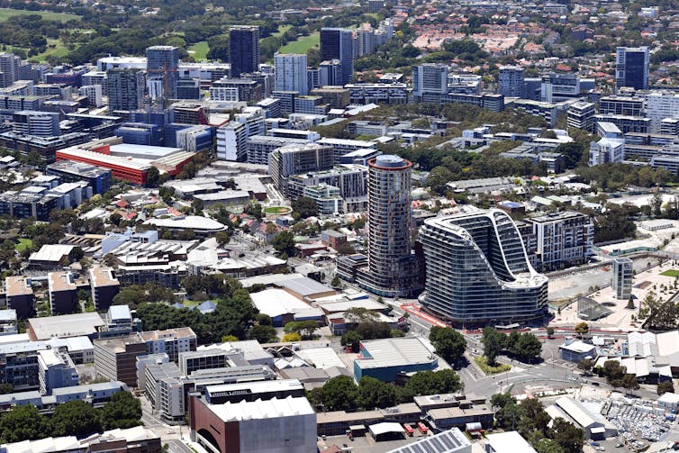 aerial view of apartment buildings and green space in an urban development area