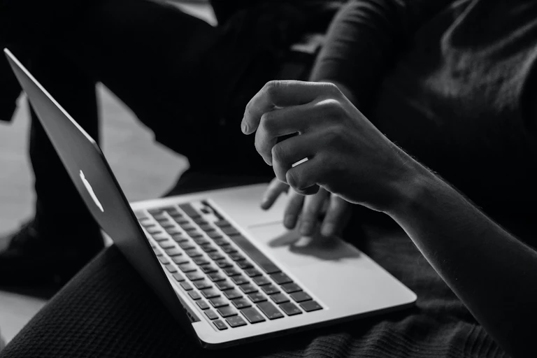 Person typing on a computer.