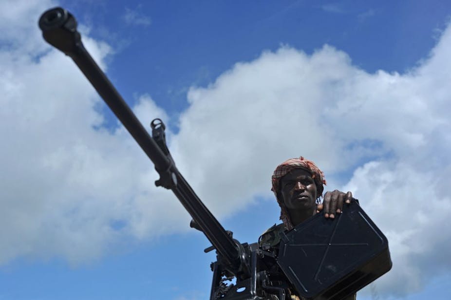 A soldier mans a mounted machine gun