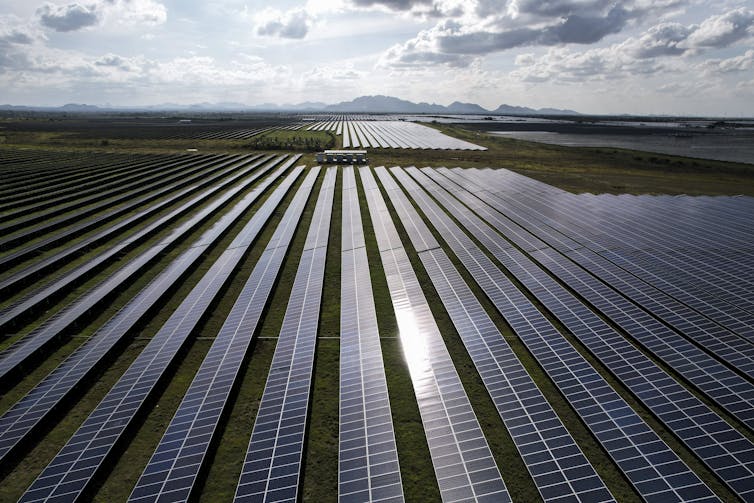 Solar panels laid down in a large open area.