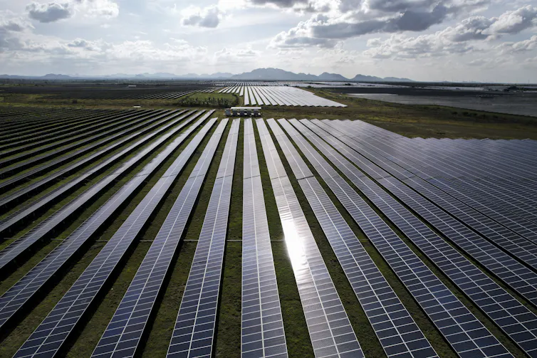 Solar panels laid down in a large open area.