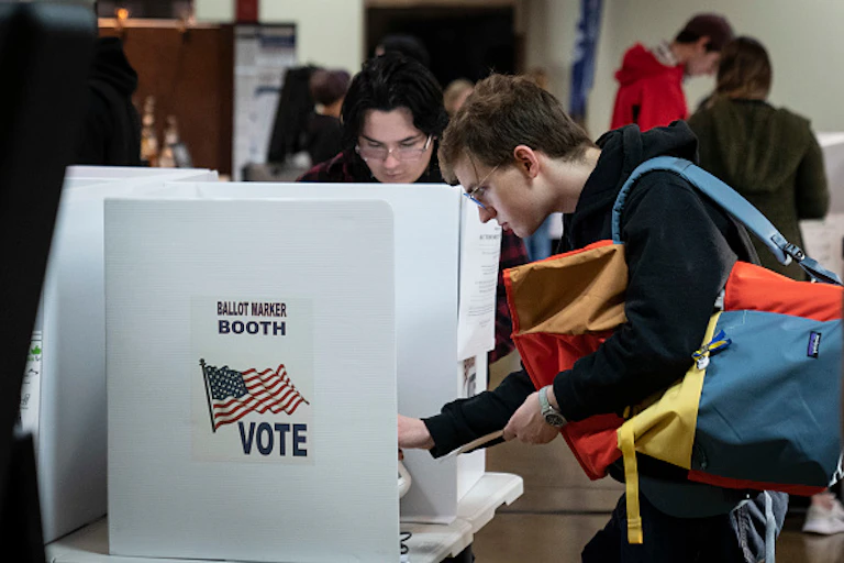 A man in front of a polling booth