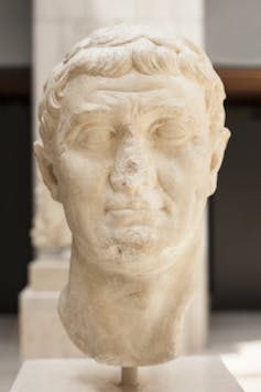 Bust of Cleopatra's husband, Roman General Mark Antony, at the National Archeological Museum of Madrid. Made from white stone, the nose partially eroded, the bust faces the camera