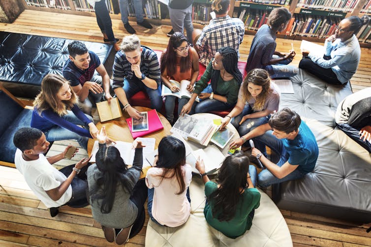 A birds-eye view of a group of university students working together.