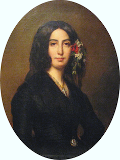 An oval portrait of a dark-haired woman with flowers in her hair.