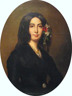 An oval portrait of a dark-haired woman with flowers in her hair.