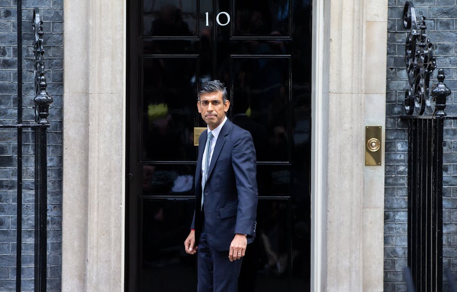 UK prime minister Rishi Sunak in front of the door to Number 10 Downing Street.