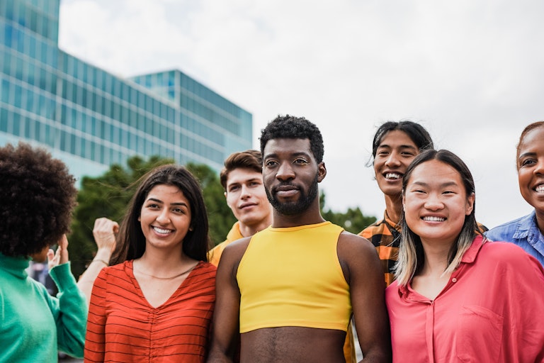 Group of people standing outside looking at camera